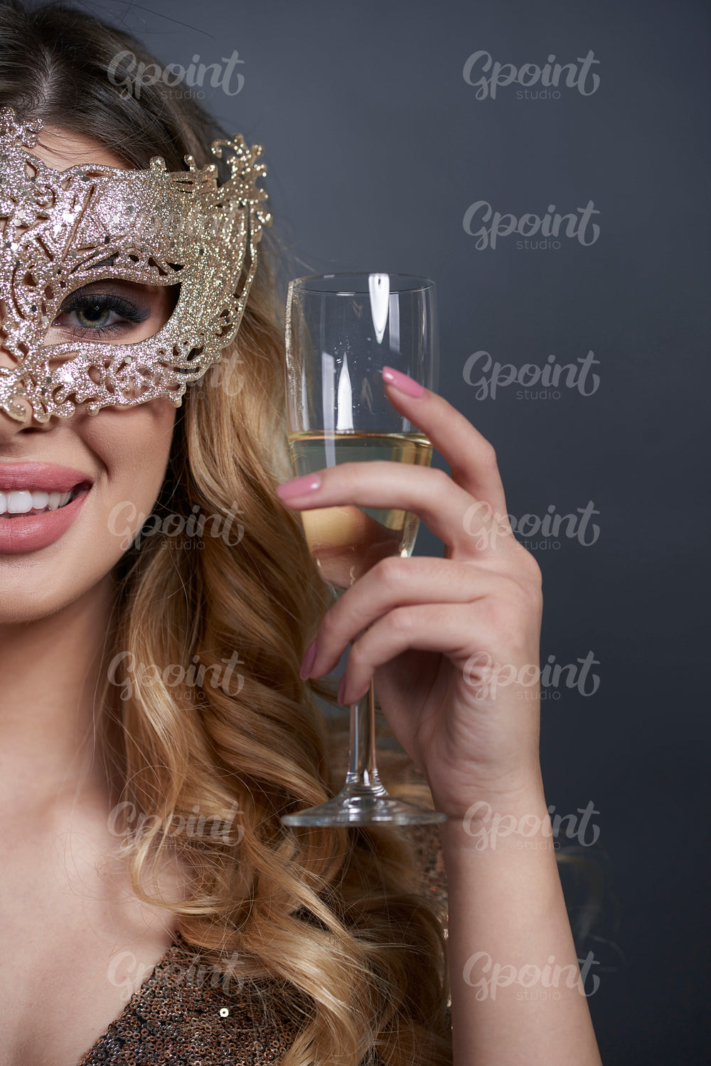 Part of woman with mask making a toast