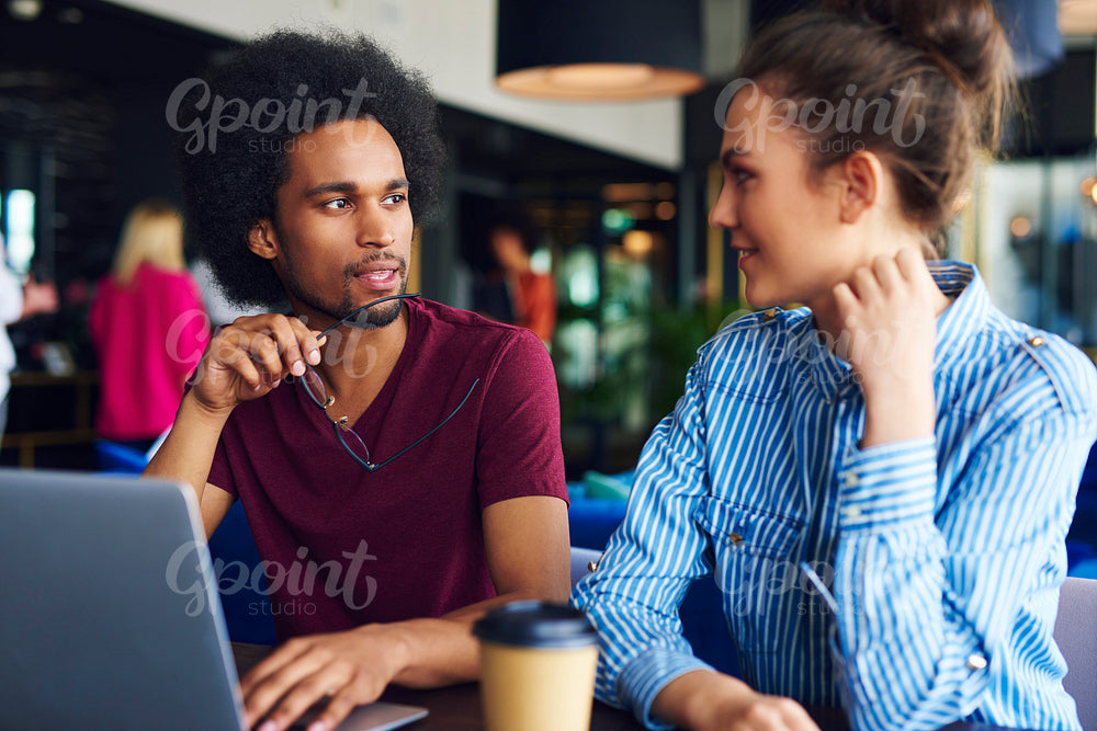 Young couple discussing at work