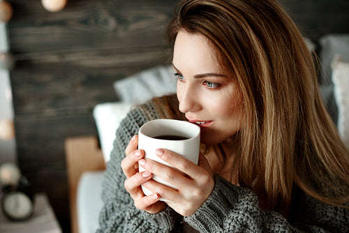 Cheerful woman drinking morning coffee