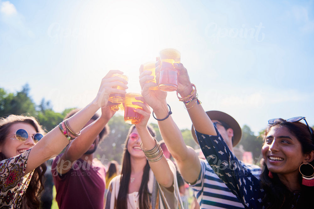 Friends making a cheers at the music festival