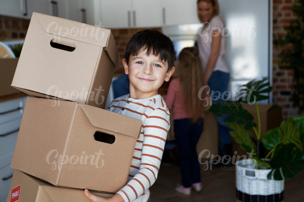Portrait of smiling boy holding a cardboard box