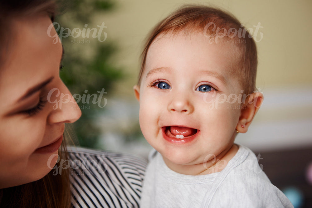 Cute baby girl showing her primary teeth
