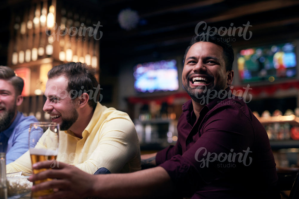 Men watching american football in the pub