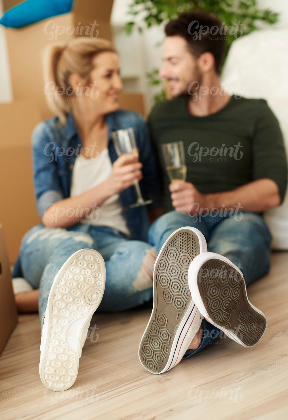Couple having toast on the floor of new flat