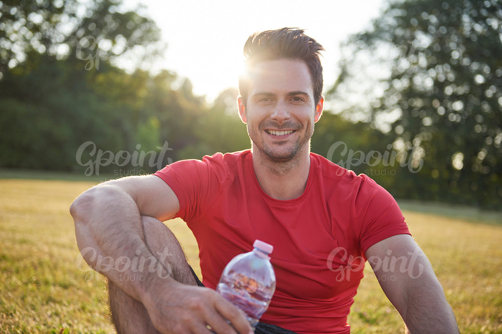 Smiling man resting after workout on the fresh air