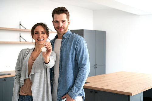 Cheerful caucasian couple holding house keys