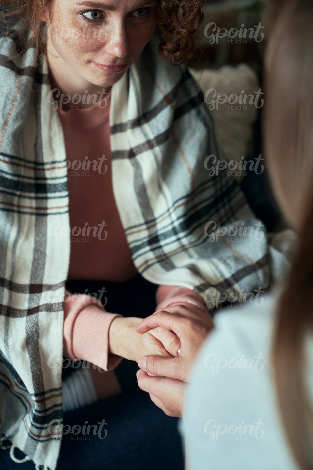 Detail of caucasian woman consoled by unrecognizable person