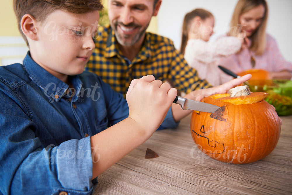 Boy making decorations for Halloween