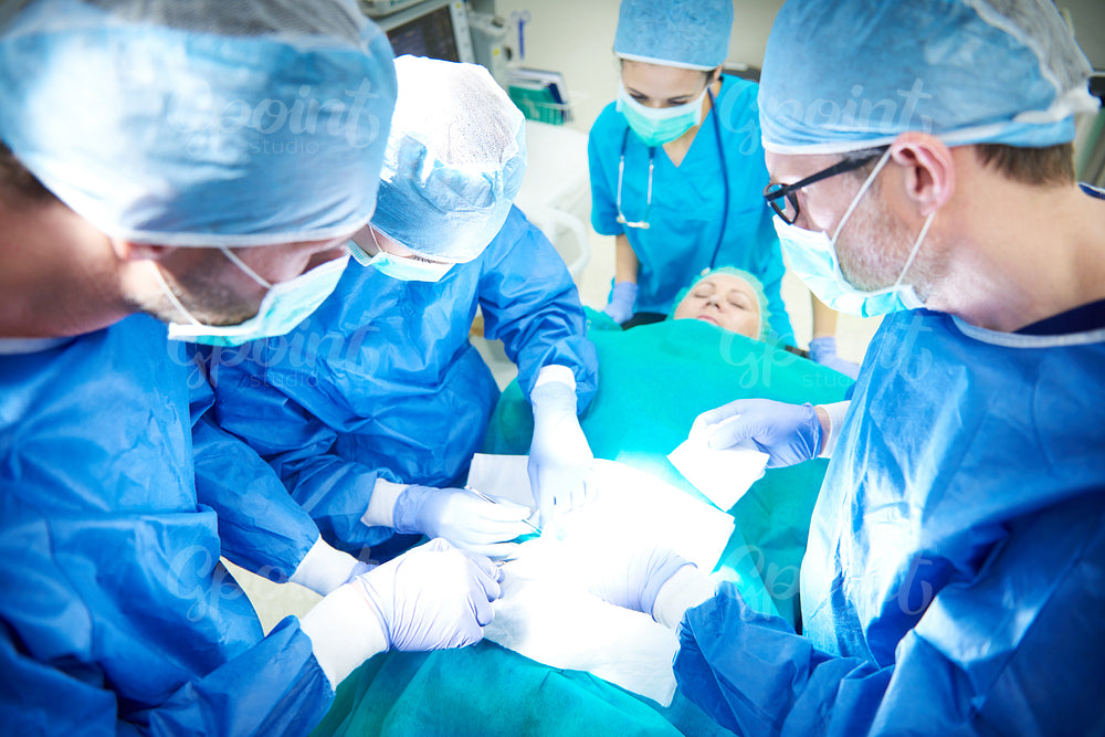 Female and male surgeon during an operation