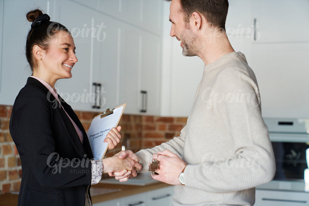 Estate agent  in the handshake of a satisfied customer