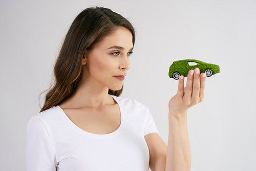 Woman looking at eco friendly car