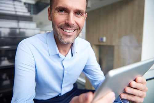 Portrait of businessman with a digital tablet