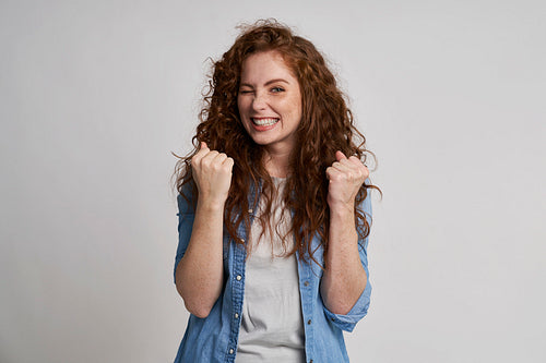 Young woman showing winning sign