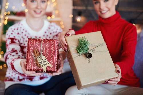 Woman's hands giving christmas presents
