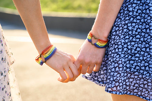 Details of holding hands with colorful bracelets