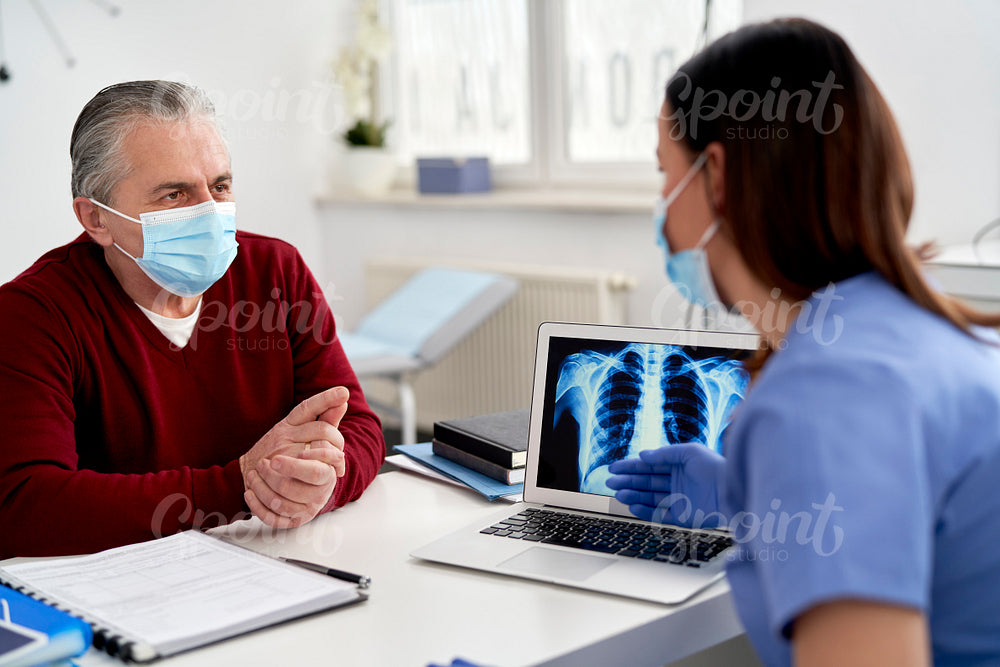 Female doctor analyzing the patient's lung X-rays