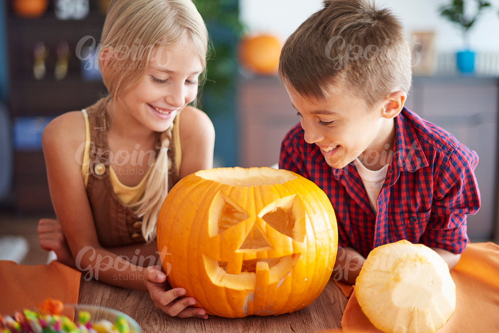 Cheerful children and carved pumpkin