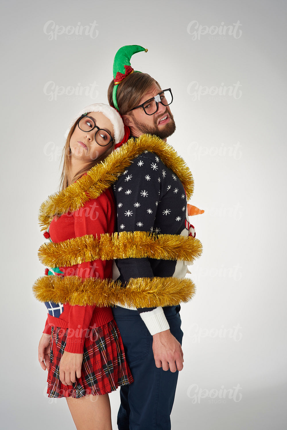 Couple wrapped in golden Christmas chain