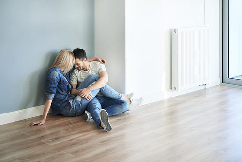 Couple sitting on the floor in their new apartment