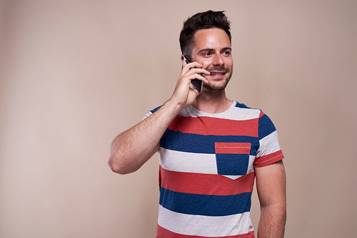 Smiling, young man is on the phone