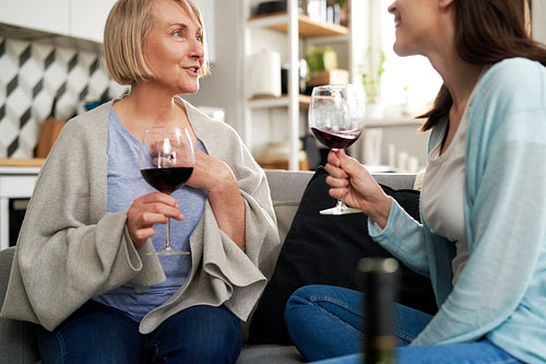 Two generation women drinking wine at home