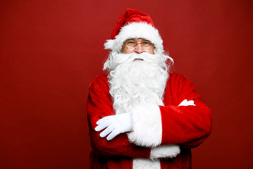 Portrait of smiling caucasian Santa Claus on red background