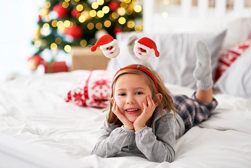 Portrait of girl lying on the bed in Christmas time