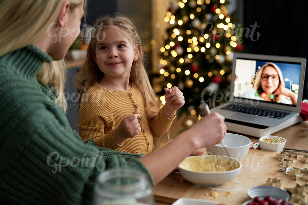 Little girl with funny face during Christmas baking with family