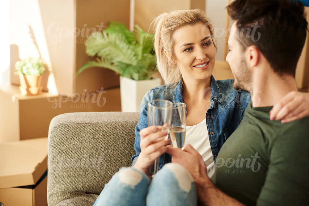 Couple chilling on the sofa with drinks