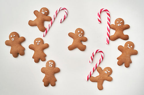 Top view of gingerbread men with candy cane