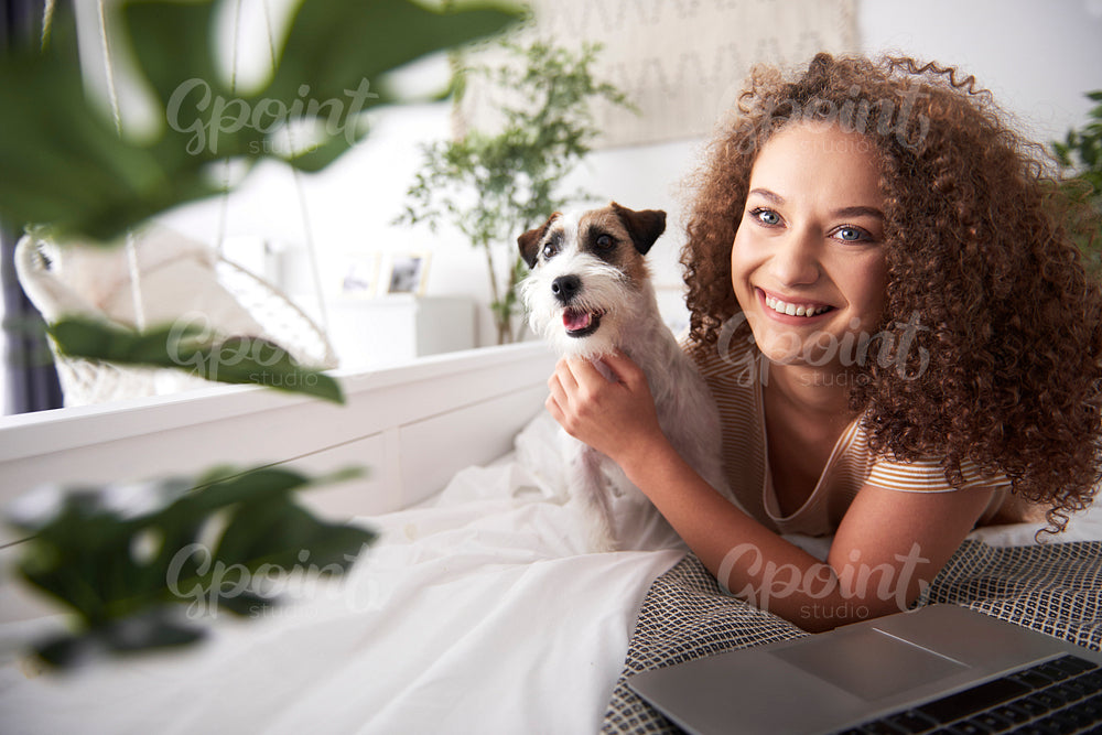 Portrait of smiling young woman and her dog