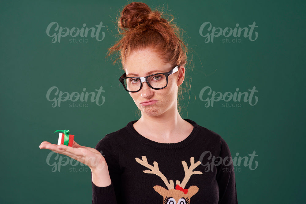 Disappointed woman holding a christmas present