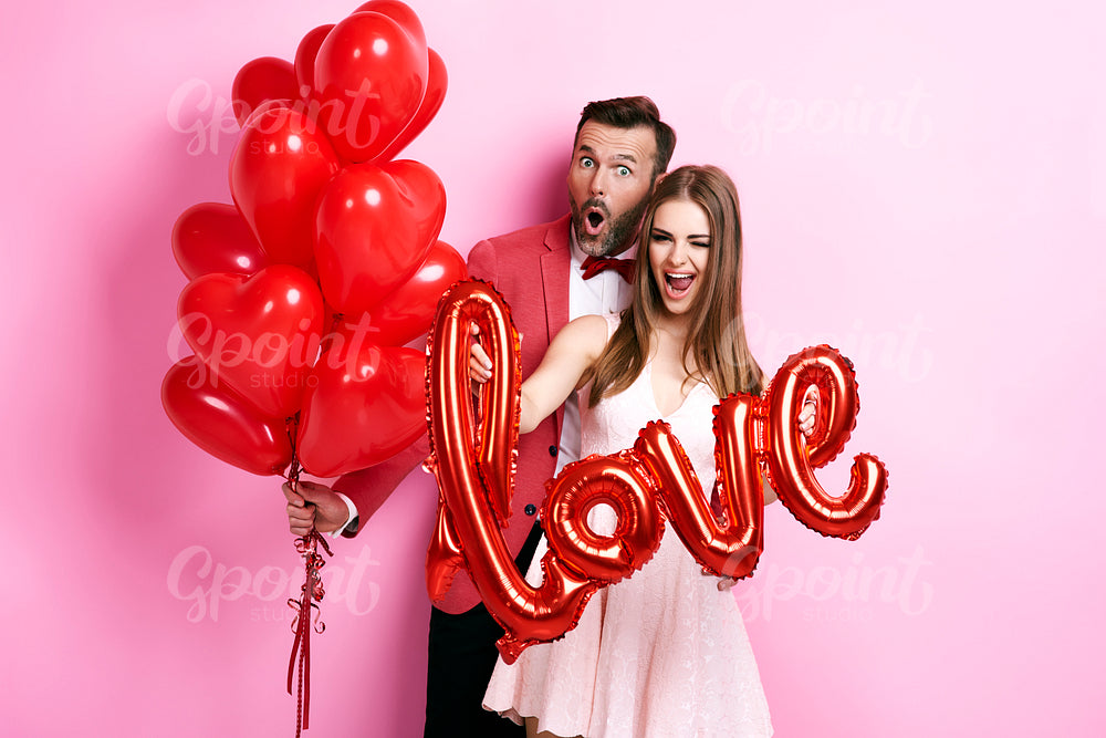 Man with balloon embracing his girlfriend