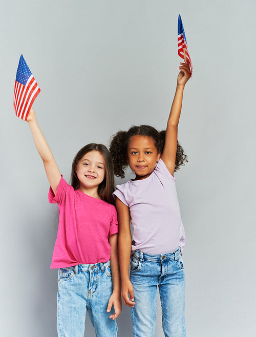 Happy girls waving American flags