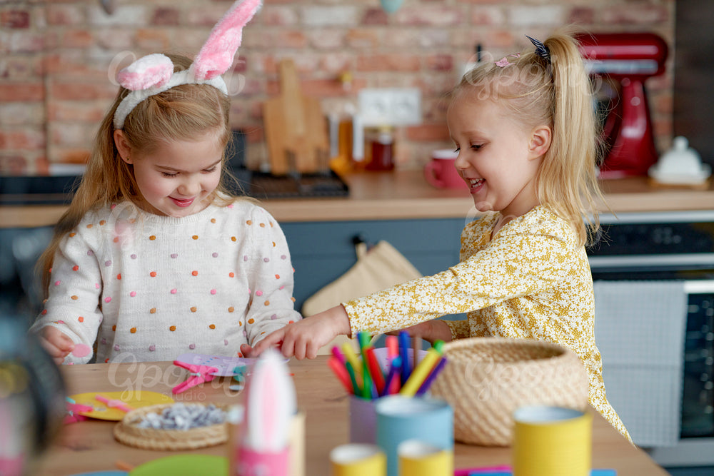 Two girls making decorations for Easter