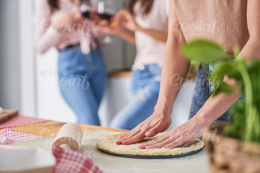 Woman forming crust for a homemade pizza