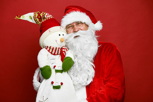 Portrait of caucasian Santa Claus with cute snowman
