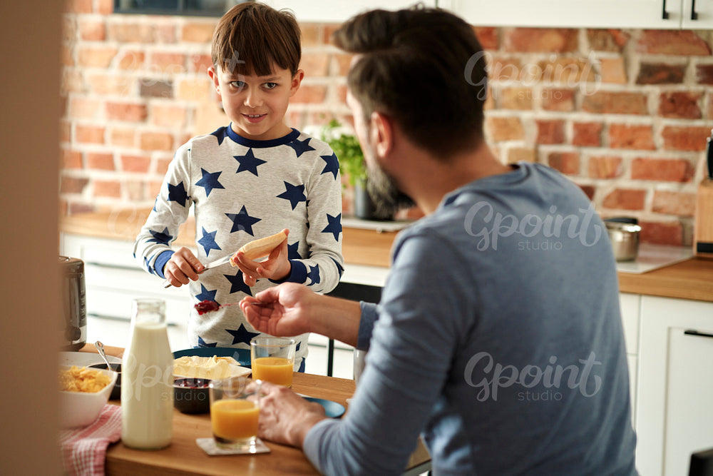 Father and son preparing breakfast together
