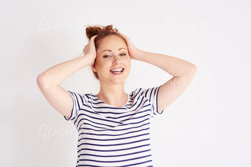 Portrait of beautiful, young woman laughing at studio shot