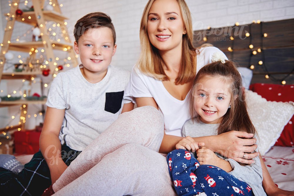 Mother and children spending christmas morning in bed