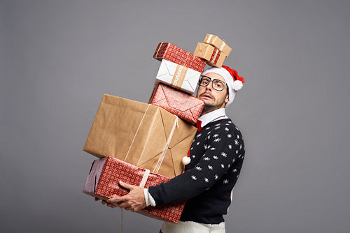 Man carrying  a lot of Christmas presents