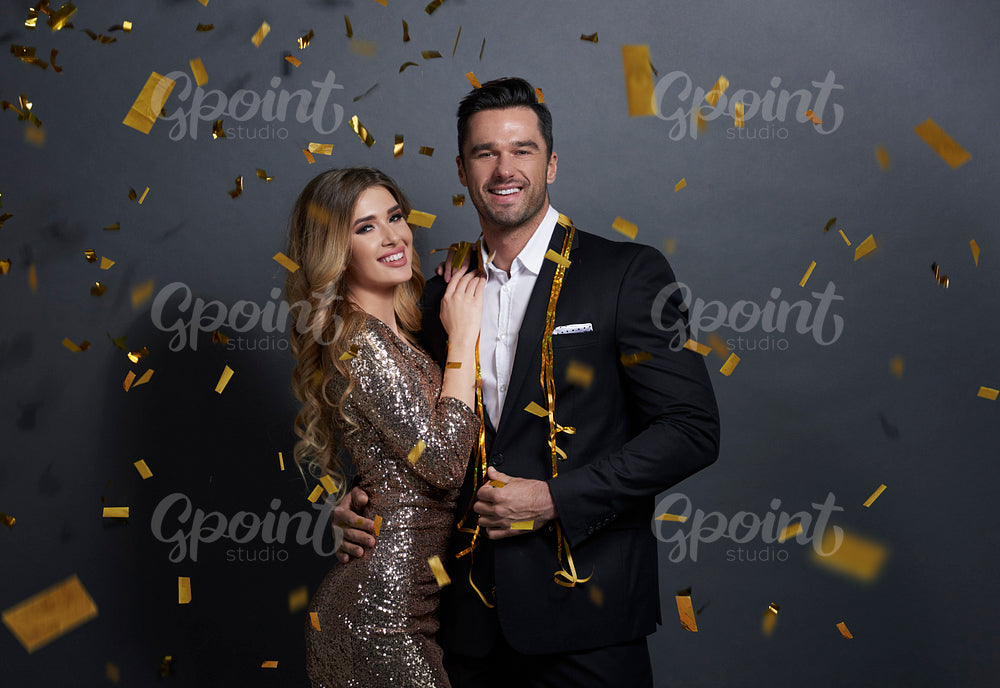 Portrait of embraced couple celebrating New Year at studio shot