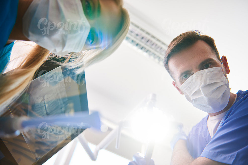 Low angle view of two dentists in dentist's clinic