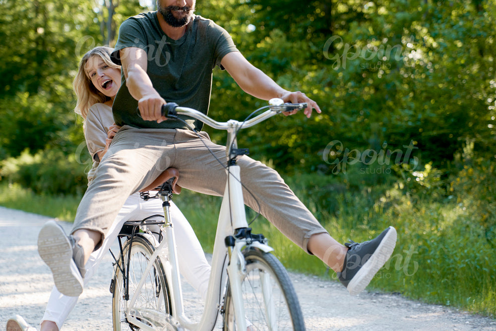 Close up of exuberant couple sharing a bicycle