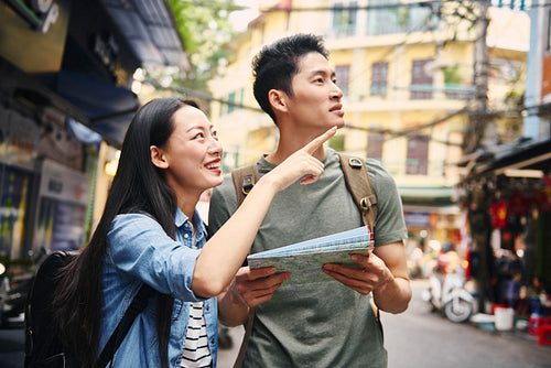 Vietnamese tourists with paper map