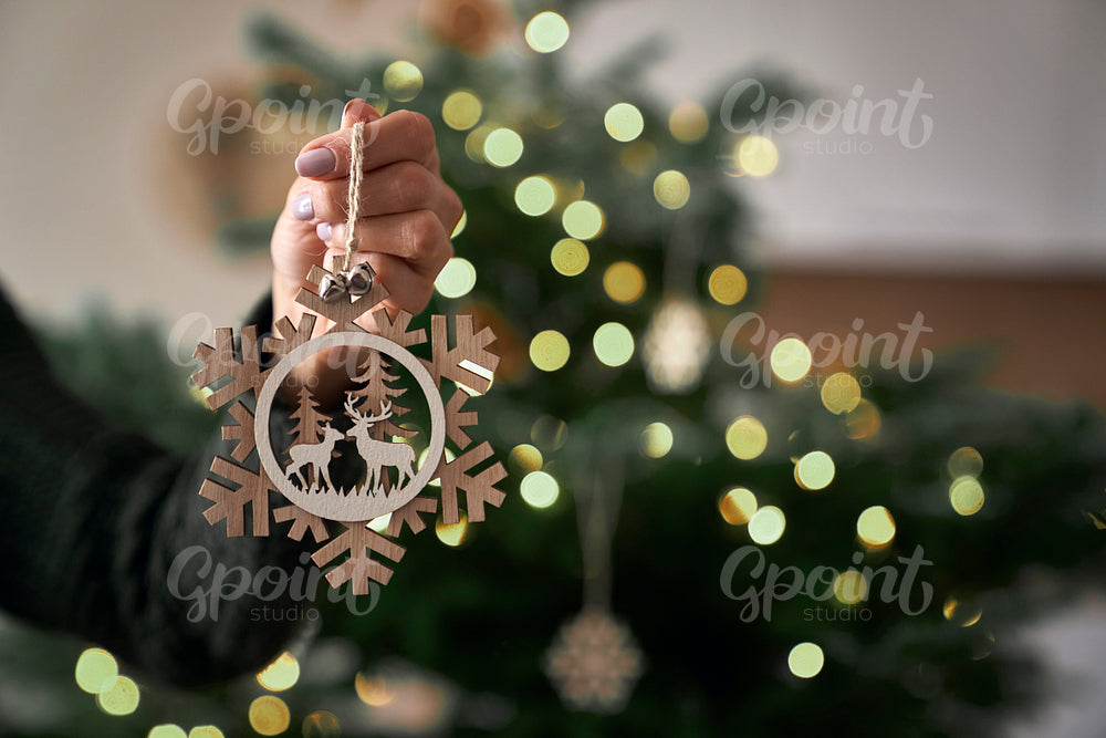 Close up of woman's hand with Christmas decoration 
