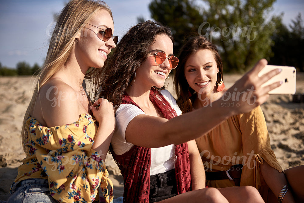 Three girls taking a selfie at the beach