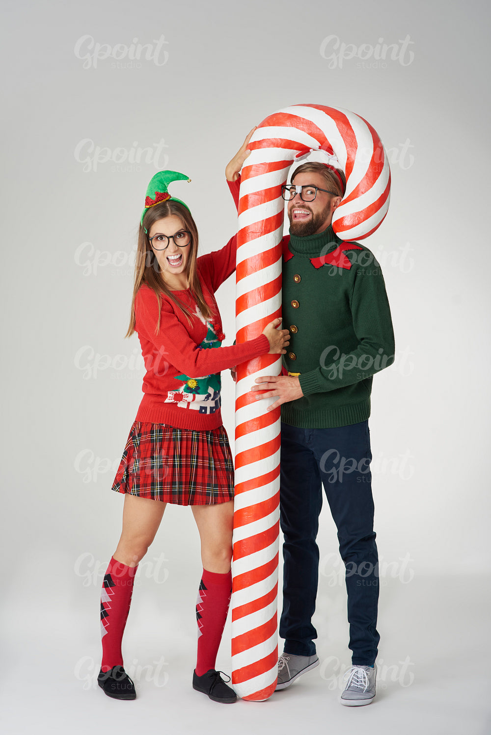 Couple posing with a huge candy cane