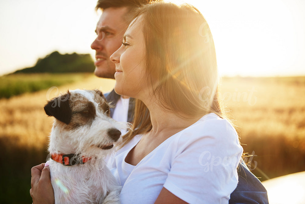 Side view of young couple and dog enjoying the view