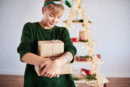 Shot of young woman holding a stack of gifts